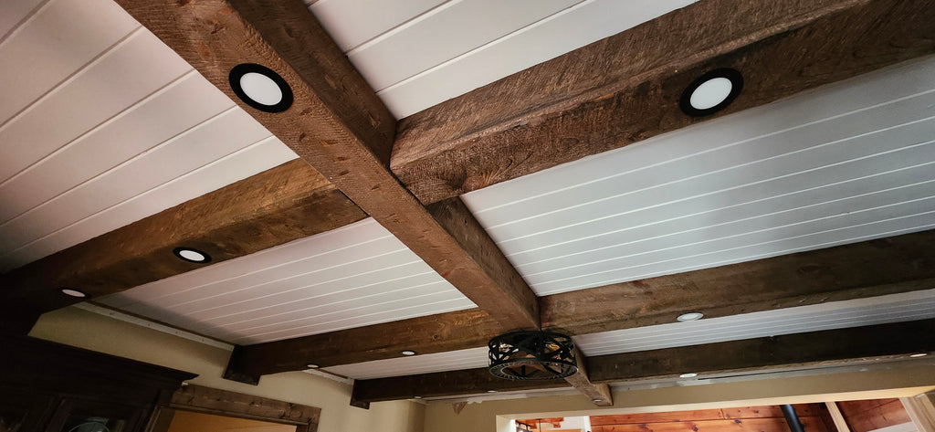 Custom made exposed architectural wood ceiling beams. They are hollow and have a rustic, distressed, rough sawn, aged and antique wood treatment to have the look of an old barn beam.