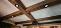 Custom made exposed architectural wood ceiling beams. They are hollow and have a rustic, distressed, rough sawn, aged and antique wood treatment to have the look of an old barn beam.