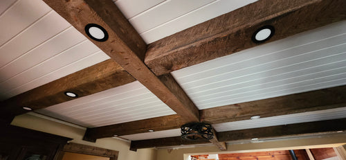 Custom made exposed architectural wood ceiling beams. They are hollow and have a rustic, distressed, rough sawn, aged and antique wood treatment to have the look of an old barn beam.